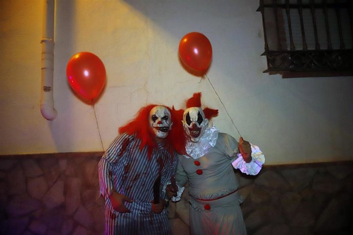 Archivo - Jóvenes disfrazados de payasos terroríficos durante la noche de Halloween (imagen de archivo)