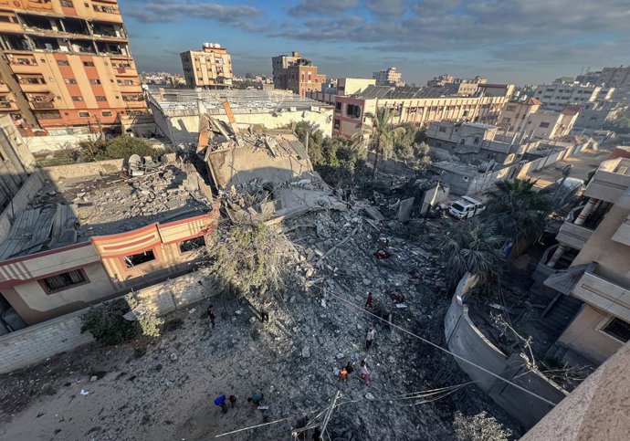 October 29, 2025, Nusairat, Gaza Strip, Palestinian Territory: Palestinians inspect the heavily damaged buildings, some of which have been completely destroyed, and collect usable items at the Nuseirat refugee camp after Israeli forces struck the central 
