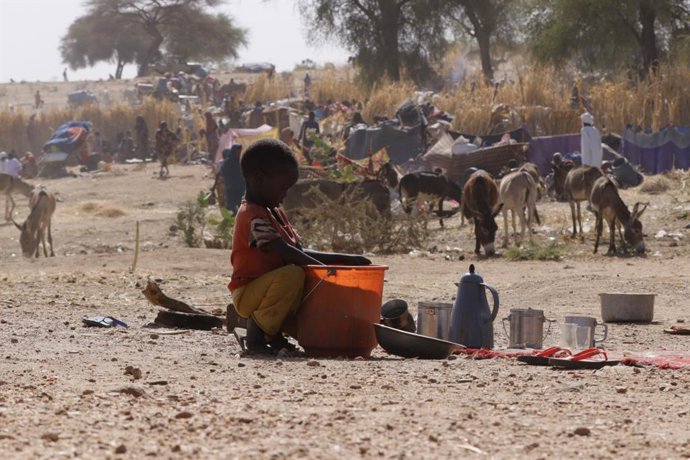 Archivo - EL FASHER (SUDÃO), 11 de julho de 2025 -- Uma criança tenta encontrar comida em um balde em um campo de deslocados em El Fasher, região de Darfur do Norte, Sudão, em 9 de julho de 2025. O Fundo das Nações Unidas para a Infância (UNICEF) disse na
