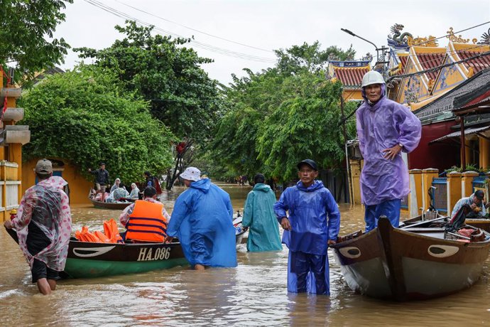 VIETNAM, HOI AN - OCTOBER 28, 2025: People are seen in a flooded street following heavy monsoon rains. Pavel Karavashkin