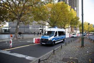 November 1, 2025, Berlin, Berlin, Germany: A Berlin police vehicle with flashing lights drives toward an operation on Saturday, November 1, 2025.