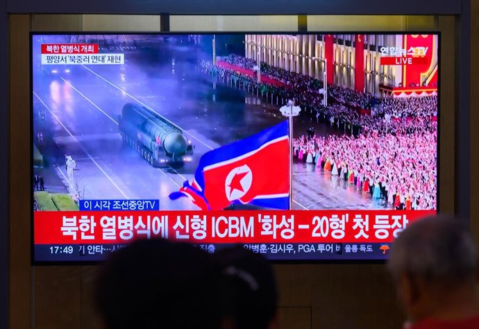 October 11, 2025, Seoul, South Korea: People look at a 24-hour Yonhap news TV broadcast at Seoul Railway Station showing a news broadcast with a Hwasong-20 Intercontinental Ballistic Missile (ICBM) display during a military parade marking the 80th anniver