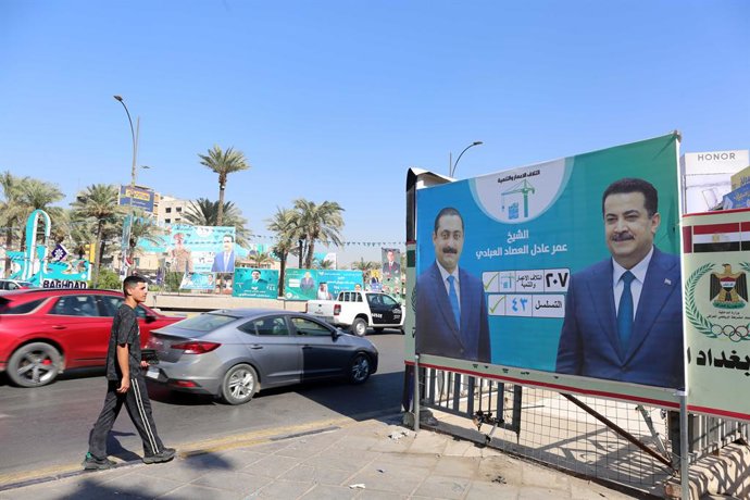 BAGHDAD, Nov. 10, 2025  -- A man looks at a campaign poster for Iraq's upcoming parliamentary elections in Baghdad, Iraq, Nov.3, 2025. TO GO WITH "Letter from Mideast: High stakes, high hopes -- Iraqis on edge before pivotal election"