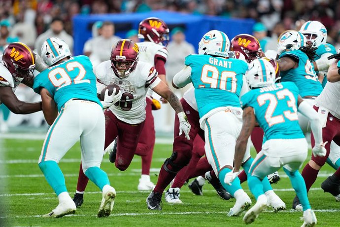 Chris Rodriguez Jr. of the Washington Commanders runs with the ball during the National Football League (NFL) 2025 Madrid Game, match played between Miami Dolphins and Washington Commanders at Bernabeu stadium on November 16, 2025, in Madrid, Spain.