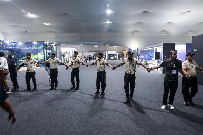 November 20, 2025, Belem, Brazil, Brazil: Security personnel form a cordon inside the COP30 venue during the evacuation following a fire in the pavilion section in Belem, Brazil. The incident prompted attendees to leave the area as emergency teams respond