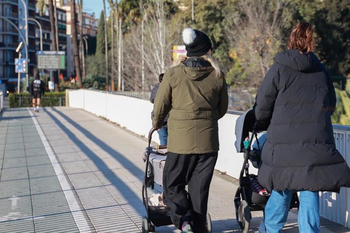 Archivo - Varias personas se abrigan para protegerse del frío. 