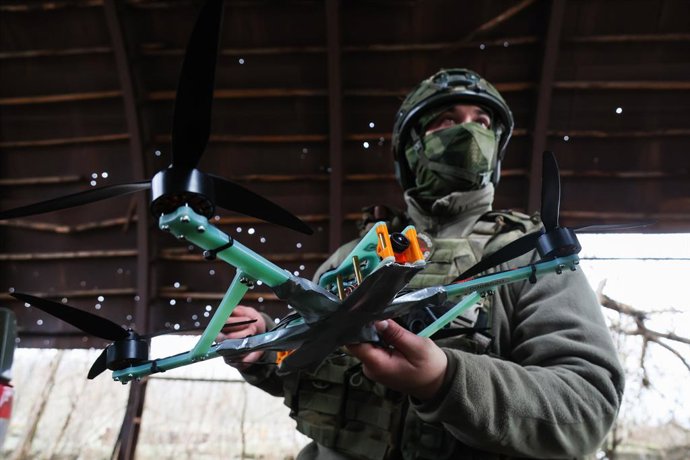 18 November 2025, Russia, ---: A member of a Russian Army 291st Regiment serviceman stands with a drone in the Zaporozhye sector of the frontline in the zone of the special military operation. Photo: Alexander Polegenko/TASS via ZUMA Press/dpa