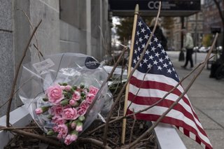 November 27, 2025, Washington, District Of Columbia, United States: A small memorial of flowers and an American flag is seen outside the Farragut West Metro station in Washington, D.C., on November 27, 2025. The tribute honors two members of the West Virg