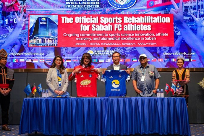 Officials from European Wellness and Sabah FC: (Pictured, from left) Dr. Natassia Sarah, Prof. Mike Chan, Tuan Md Joh Haji Wid, and Tuan Shamsuddin Bin Mohd Shah -- exchange club jerseys in a symbolic gesture marking their newly formalized partnership for