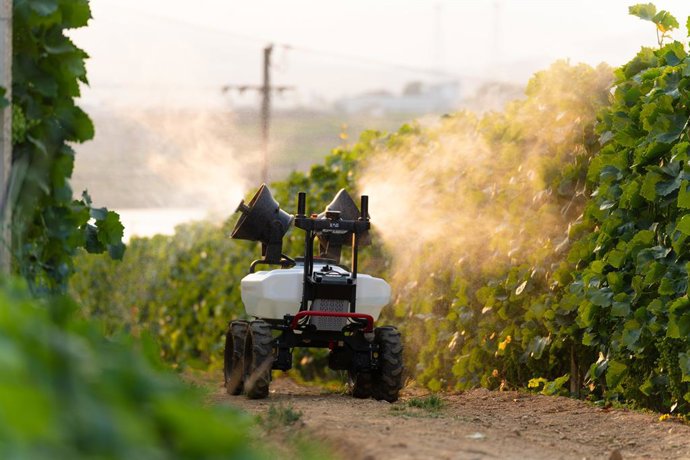 XAG R100 Agricultural Rover performs precision spraying in a vineyard.