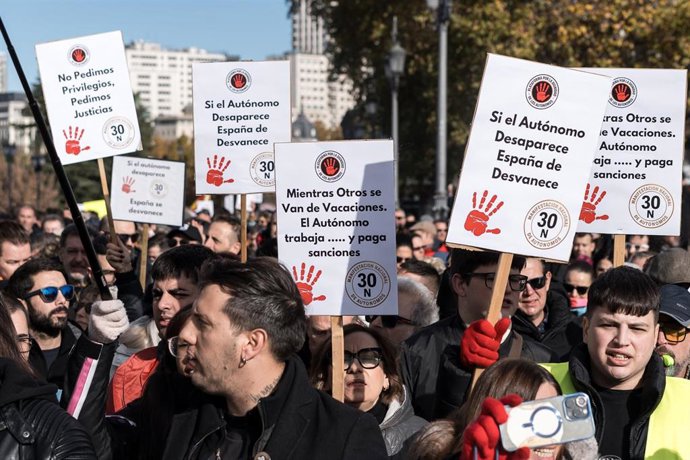 Manifestantes portan pancartas con lemas 'Mientras otros se van de vacaciones, el autónomo trabaja... y paga sanciones'