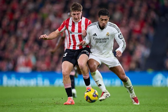 Archivo - El centrocampista español Mikel Jaureguizar (Athletic Club) intenta robar el balón al inglés Jude Bellingham (Real Madrid), en el partido de LaLiga EA Sports 2024-25 disputado en San Mamés.