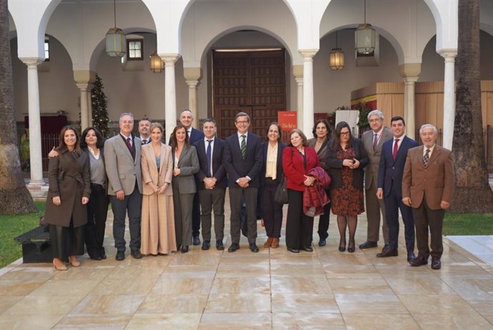 Representantes de la FAMP rodean al consejero de Industria, Jorge Paradela, ante el debate final de la Ley de Espacios Productivos, celebrado este martes en el Pleno del Parlamento.