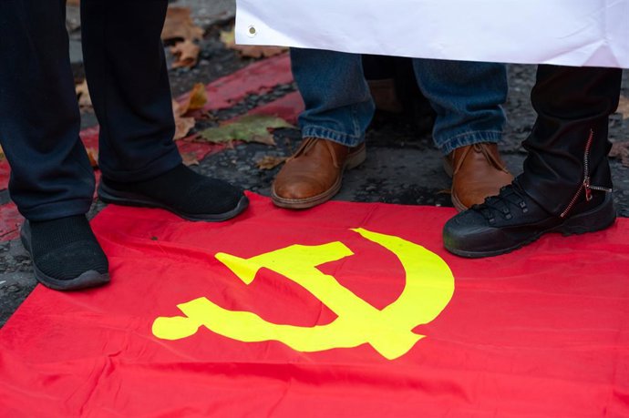 November 15, 2025, London, United Kingdom: Protesters step on the Chinese flag during the demonstration. Protesters marched to Royal Mint Court to oppose the construction of a Chinese Communist Party mega-embassy, which campaigners say poses a threat to U