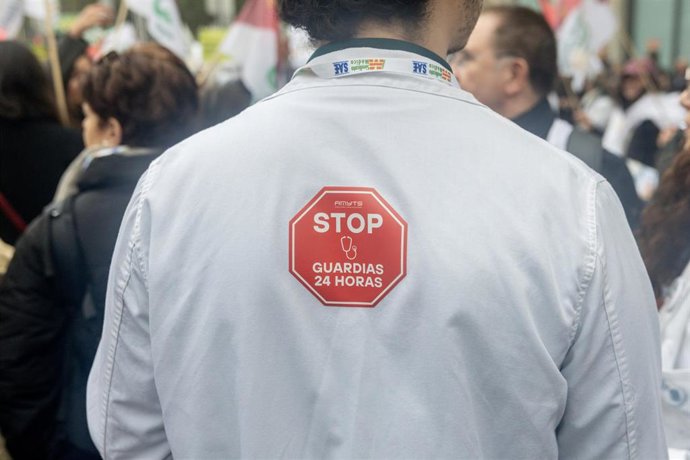 Manifestante con pancarta con lema 'Stop guardias 24 horas' durante la manifestación. Imagen de archivo. 