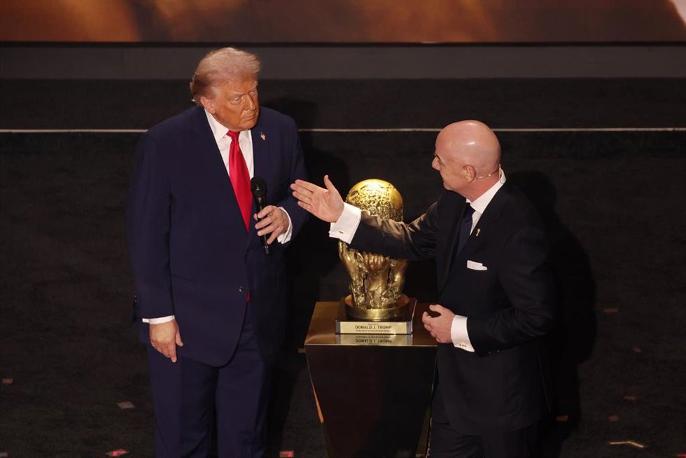 04 December 2025, US, Washington: US President Donald Trump is presented with the inaugural FIFA Peace Prize award by FIFA President Gianni Infantino during the 2026 FIFA World Cup draw at the John F. Kennedy Center for the Performing Arts in Washington