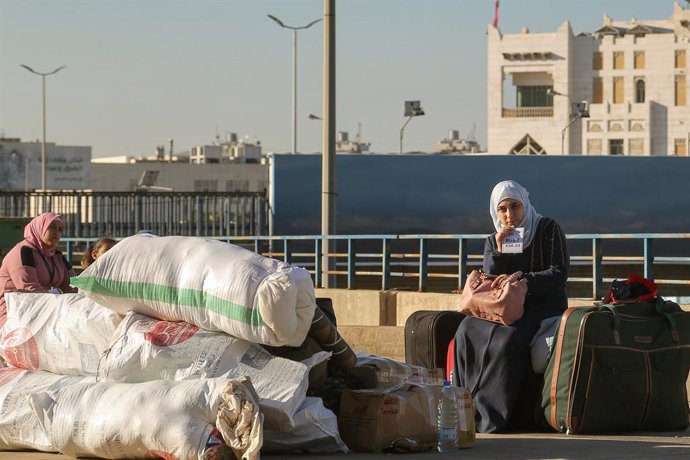 October 15, 2025, Beirut, Beirut, Lebanon: A Syrian refugee  sits on belongings as she waits with her family to depart home from Beirut. At least 400 refugees left to Syria during the fifth phase of voluntary departure organized by the UNHCR and IOM and L