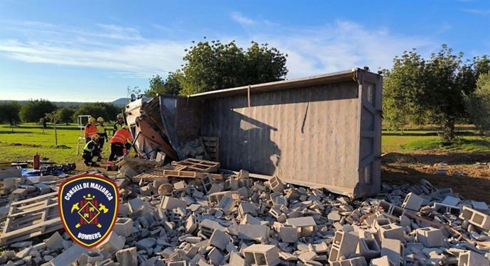 Un camión que transportaba material de construcción, volcado en la Ma-5040.