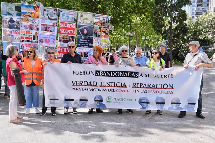 Archivo - Varias personas sostienen una pancarta que reza: 'Fueron abandonadas a su suerte. Verdad, justicia y reparación para las víctimas del Covid-19 en las residencias' frente a los Juzgados de Plaza de Castilla, a 15 de junio de 2023, en Madrid (Espa