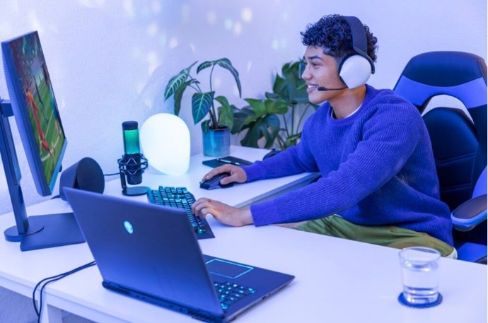 Um menino jogando em um computador desktop com Windows.