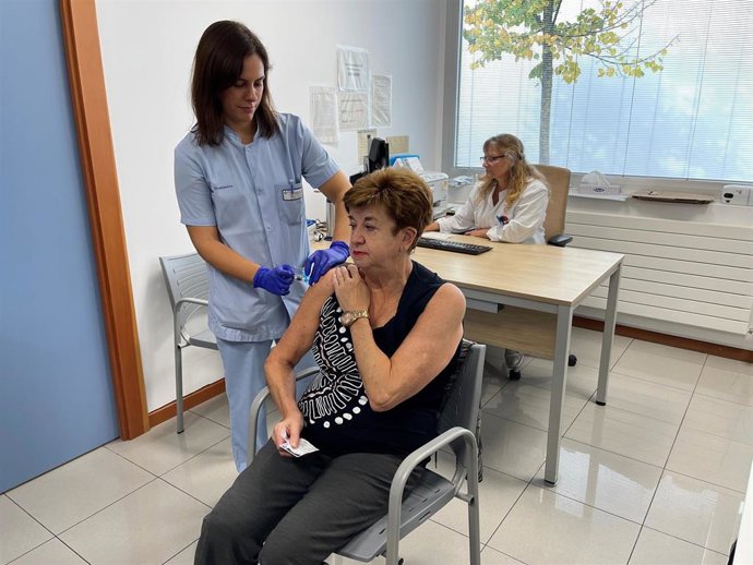 Una enfermera vacuna a una persona mayor.