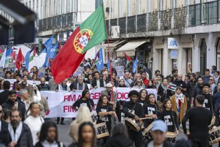 November 29, 2025, Lisbon, Portugal: Activists are seen marching with flags and banners during a pro-Palestinian protest. On the occasion of the International Day of Solidarity with the Palestinian People, several social organizations participated in a la