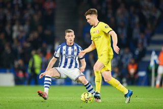 Sergio Gomez of Real Sociedad competes for the ball with Viktor Tsygankov of Girona FC during the LaLiga EA Sports match between Real Sociedad and Girona FC at Anoeta on December 12, 2025, in San Sebastian, Spain.