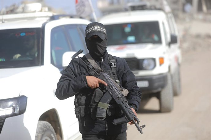 8 de dezembro de 2025, Cidade de Gaza, Faixa de Gaza, Território Palestino: Equipes afiliadas à ala militar do Hamas, as Brigadas Al-Qassam, e funcionários do Comitê Internacional da Cruz Vermelha (CICV), juntamente com maquinário pesado pertencente ao Eg