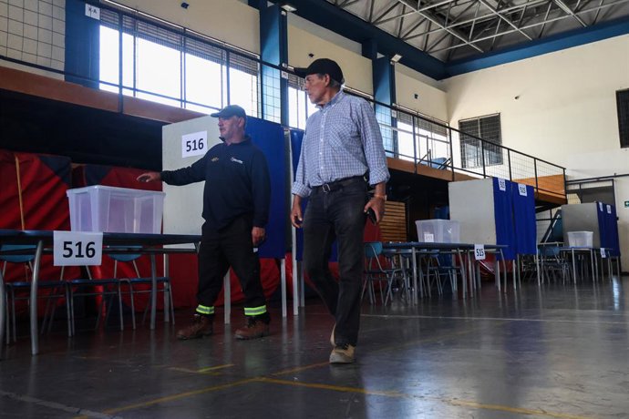 December 12, 2025, Valparaiso, Chile: Two municipal officers check the preparation of the polling station for the second round of the Presidential Election, Chile 2025. Public staff prepare polling place for second round of presidential election, Chile 20
