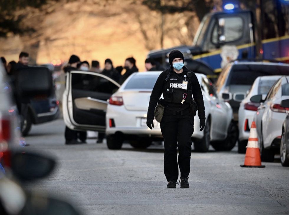 19 February 2022, US, Baltimore: Police work at Chilton street and Hillen road in Baltimore following a shooting earlier in the day in which police officers shot and killed a suspect that was allegedly accelerating toward them on Chilton Street.