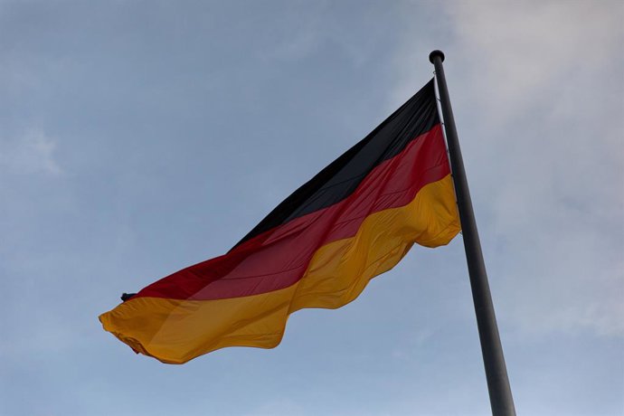 December 14, 2025, Berlin, Berlin, Germany: The German flag flies above the Reichstag building in Berlin, Germany, on Sunday, December 14, 2025. Police barriers and security preparations were visible around the parliament complex amid heightened alert lev