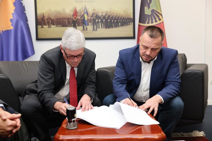 From Left: John Chadbourne, AM General EVP, Business Development and Ejup Maqedonci, Minister of Defense of the Republic of Kosovo finalize the 3-year contract award for HUMVEE 2-CT Hawkeye and other HUMVEE variants, parts, and service support
