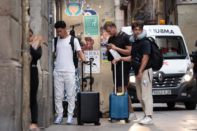 Archivo - Diverses persones amb maletes al centre de Barcelona