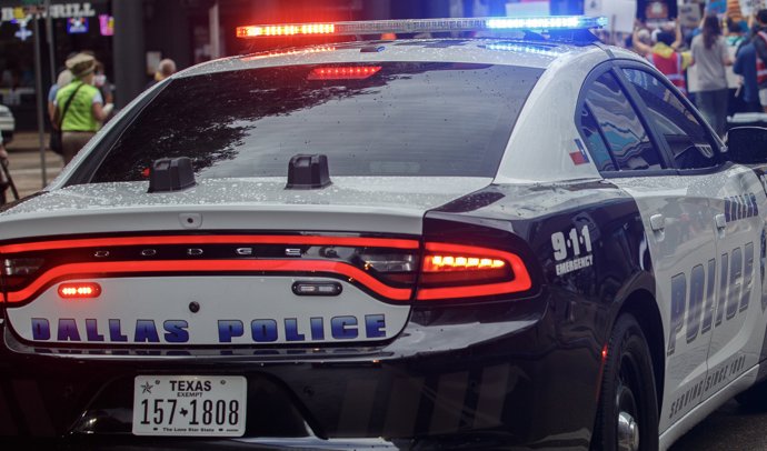 October 18, 2025, Dallas, Texas, USA: A Dallas Police Department vehicle escorts protesters down Elm Street  in downtown Dallas Texas,as they march during the No Kings protest n downtown Dallas Texas on Saturday.