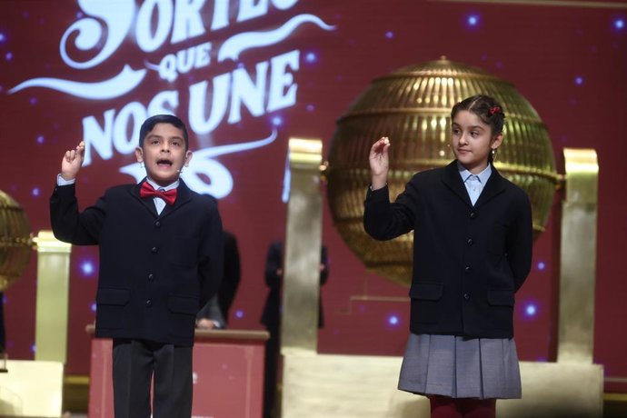 Dos niños del Colegio de San Ildefonso, cantan el tercer premio de la Lotería de Navidad, durante la celebración del Sorteo Extraordinario de la Lotería de Navidad 2025, en el Teatro Real, a 22 de diciembre de 2025, en Madrid (España). 