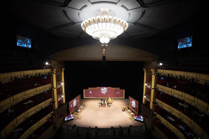 Varias personas ven como los niños del Colegio de San Idefonso cantan los números premiados durante la celebración del Sorteo Extraordinario de la Lotería de Navidad 2025.