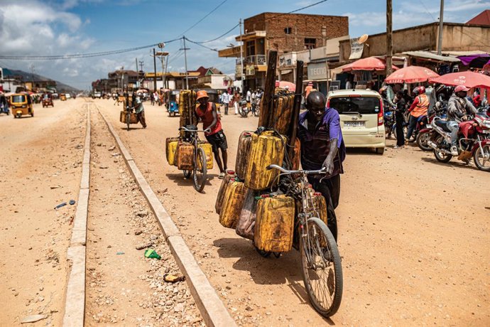 UVIRA, Dec. 15, 2025  -- People transport goods by bike in Uvira, a city in South Kivu Province in the eastern Democratic Republic of the Congo (DRC), on Dec. 15, 2025. In Uvira, a strategic city in eastern DRC, streets are being swept, shops are cautious