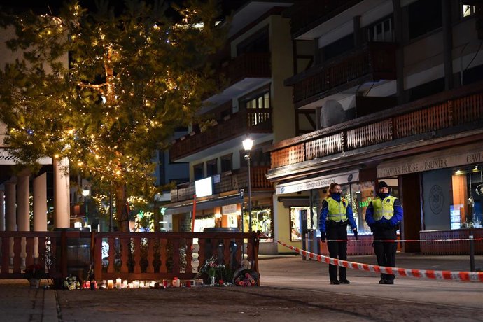 CRANS-MONTANA, Jan. 2, 2026  -- Candles and flowers to mourn the victims of a fire at a bar in the Crans-Montana ski resort are pictured in Valais Canton of southwestern Switzerland, Jan. 1, 2026. Around 40 people were killed and more than 110 others inju