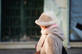 Imagen de archivo de transeúntes protegiéndose del frío 