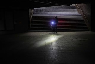 03 January 2026, Berlin: A man rides his bicycle through Wannsee station after a power outage in Berlin.  After a cable bridge caught fire, 50,000 households and 2,000 businesses in south-west Berlin lost power. Photo: Michael Kappeler/Dpa/dpa