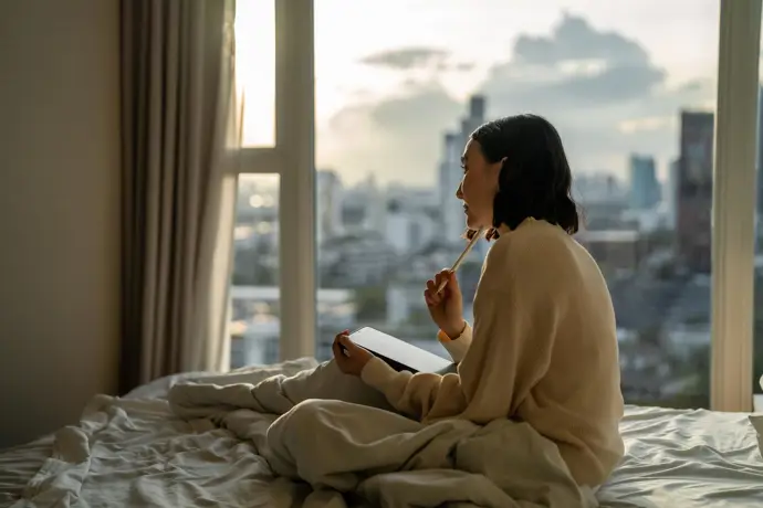 Mujer escribiendo en un cuaderno, relajada
