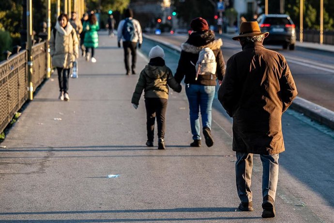 Transeúntes cruzan el Puente de Triana durante la ola de frío a 07 de enero del 2026  en Sevilla.