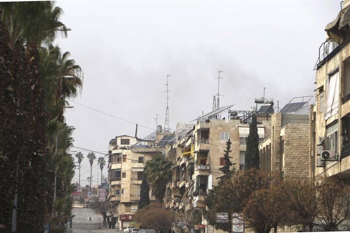 DAMASCUS, Jan. 8, 2026  -- Smoke rises over residential buildings near the Ashrafieh neighborhood in Aleppo city, Syria, Jan. 8, 2026. The Syrian army on Thursday launched intense shelling targeting positions of the Syrian Democratic Forces (SDF) in the S