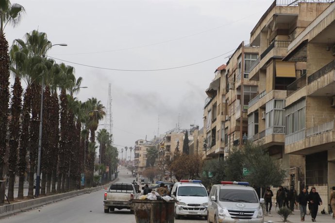 DAMASCUS, Jan. 8, 2026  -- Syrian security vehicles are seen parked along a street outside the Ashrafieh neighborhood in Aleppo city, Syria, Jan. 8, 2026. The Syrian army on Thursday launched intense shelling targeting positions of the Syrian Democratic F