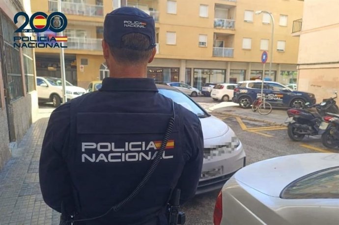 Un agente de la Policía Nacional de espaldas. Recurso.
