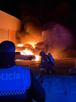 Tareas para sofocar el incendio que ha afectado a seis vehículos y una empresa en la capital palentina.