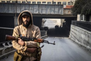 07 January 2026, Syria, Aleppo: A Syrian government soldier stands guard on the road leading to Sheikh Maqsoud and Ashrafieh neighborhoods of Aleppo, following renewed clashes between Kurdish forces and government troops. The Syrian interim government in 