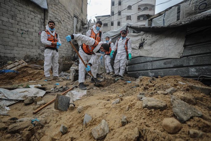 15 de janeiro de 2026, Territórios Palestinos, Gaza: Equipes de defesa civil na província de Gaza estão transferindo aproximadamente 50 corpos de um cemitério não autorizado para sepultamento em cemitérios oficiais. Foto: Omar Ashtawy/APA Images via ZUMA 