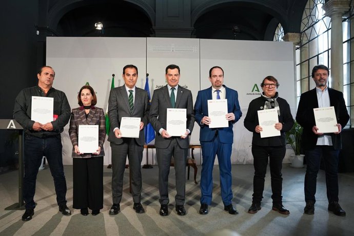 El presidente de la Junta de Andalucía, Juanma Moreno (c), acompañado del consejero de Justicia, José Antonio Nieto (3i), tras la firma del acuerdo. A 26 de enero de 2026, en Sevilla (Andalucía, España). 