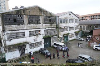 Varias personas durante el desalojo de uno de los pabellones okupados en el barrio de Herrera.